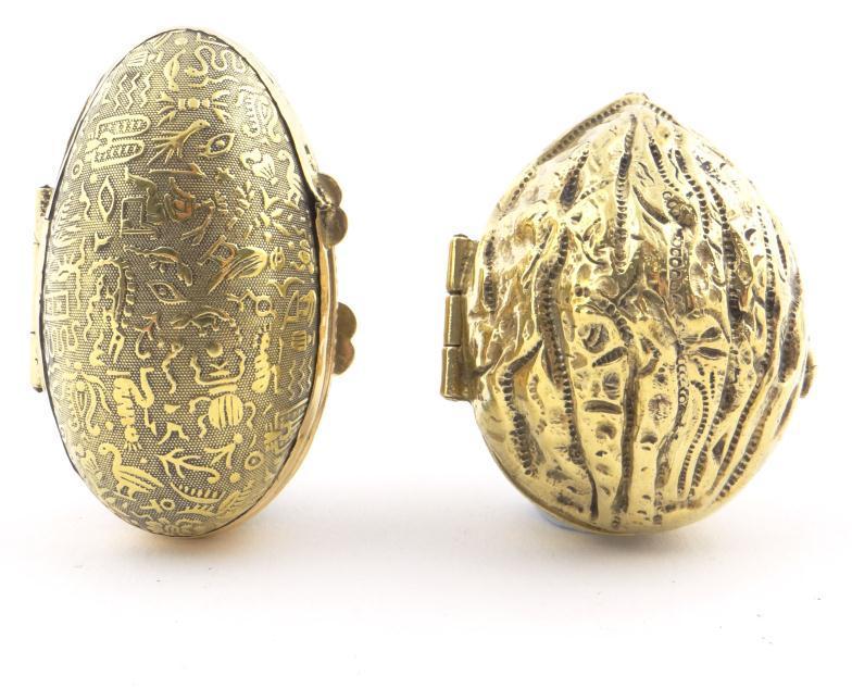 Brass walnut design thimble case and a similar egg shaped example with relief cast decoration,