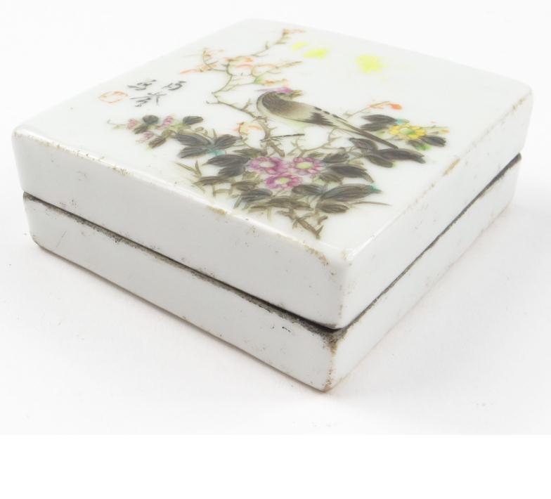 Square oriental porcelain box enamelled in the famille rose palette with a bird amongst flowers,