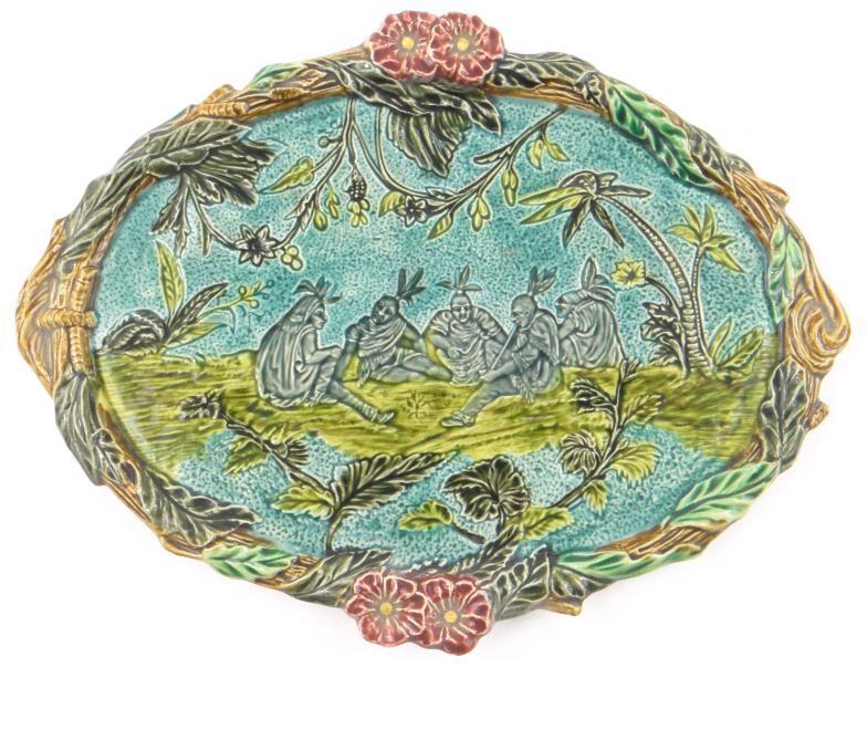 Oval Continental Majolica platter decorated with native Americans flanked by foliage, 35cm in length