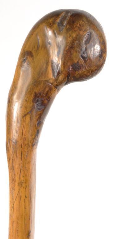 Naturalistic wood walking cane with carved globular terminal, 81cm high : For Condition Reports