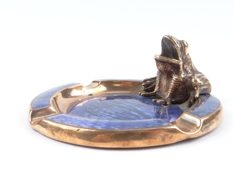 Copper and purple guilloche enamelled ashtray surmounted with a frog to the rim, 8cm diameter :