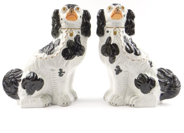 Pair of large Victorian pottery spaniels with black painted spots and gilt highlights, 32cm high :