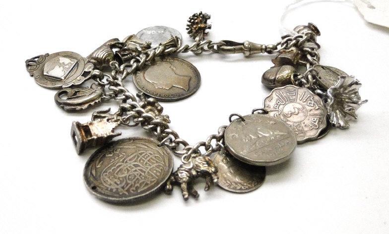 Silver bracelet with a selection of silver and other charms : For Condition Reports Please visit