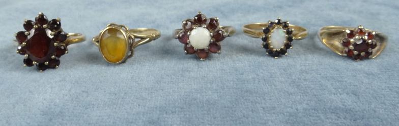 Four 9ct gold rings set with assorted stones and a silver ring : For Condition Reports Please