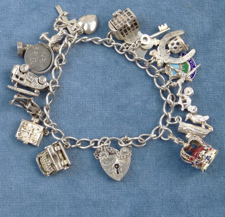 Silver charm bracelet with a selection of charms : For Condition Reports Please visit www.