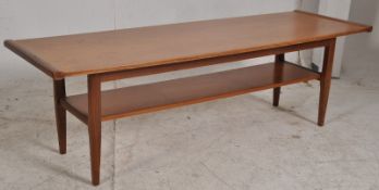 A retro 1960's Danish teak wood coffee table in the manner of mogens kolo. Raised on tapered