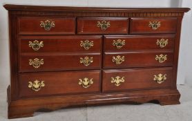A Georgian style twin mahogany chest of drawers. Raised on plinth base having short drawers over