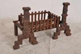 A pair of 18th century fire side andirons in cast iron, along with a matched cast iron firegrate.
