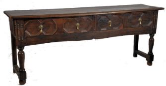 An 18th century peg jointed Jacobean country oak dresser base / sideboard. Raised on block and