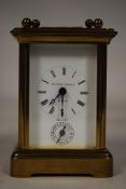 A 20th century miniature Matthew Norman of London carriage clock. Miniature case with enamel face
