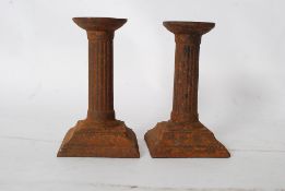 Pair of cast iron candle sticks roman numerals to underside of base MDCCLXIII for 1763 together with