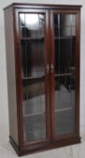 A good quality mahogany display cabinet having full length glazed doors with wooden shelves