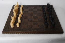 A vintage reproduction Oriental Chess set. Each piece being carved wood in fine detail, with