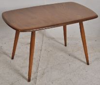 A low 20th century Ercol beech and elm wood occasional table  ( Golden Dawn ) Raised on tapered legs