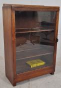 A 1930's Art Deco mahogany bookcase display cabinet. Inset plinth base with glazed door having