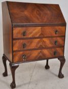 A 1930's quarter veneer flame mahogany queen anne bureau. Fall front slope having appointed interior