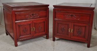 A pair of Chinese hardwood bedside cabinets / large side cabinets, each fitted with two doors and