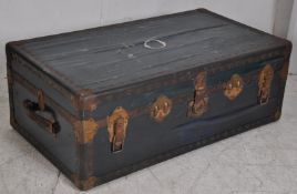 A vintage 20th metal bound steamer trunk having hinged top with clasps to centre. H33cm x W92cm x
