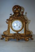 19th century French gilt metal 8 day mantel clock, The gilt metal body adorned with cherub over