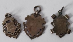 3 Antique hallmarked silver watch fob / medals. Each ornately decorated to front, one with engraving