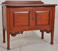 An Edwardian style mahogany hall cupboard. Square tapered legs with carved apron under double doors.