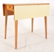 A continental 1950's yellow formica drop leaf kitchen table having tapered legs with fitted frieze