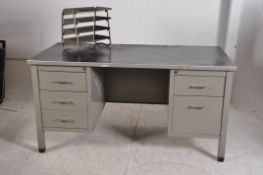 An original 1950's industrial metal office desk. The desk having raised pedestals with 6 drawers