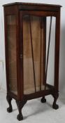 A 1930's Art Deco oak bow front display cabinet. Raised on ball and claw feet with upright glazed