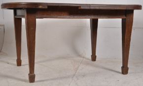 A Victorian Arts & Crafts oak dining table. Raised on square tapered legs with spade feet having