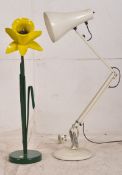 A vintage Daffodil anglepoise lamp with bold yellow flower on a green metal base, along with another