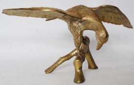 A decorative 20th century large brass eagle mounted to natural style plinth base.