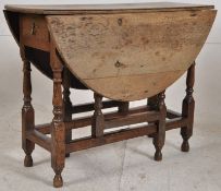 An 18th century country oak peg jointed drop leaf / gate leg dining table. The block and turned legs