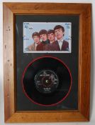 A framed and glazed 7" vinyl record single of The Beatles first pressing of She Loves You matrix