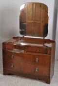 A 1930's Art Deco oak bow front dressing table.The serpentine shaped body having dressing mirror