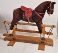 A vintage rocking horse, full size on a wooden base, being Made In England by Pegasus.