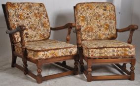 2 good Ercol beech and elm golden dawn armchairs complete with cushions having Jacobean revival