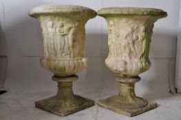 A good large pair of campana shaped garden urns  raised over tall plinth having shaped bowls with