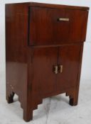 A 1930's walnut and bakelite metamorphic gramaphone cabinet having fall front with cabinet
