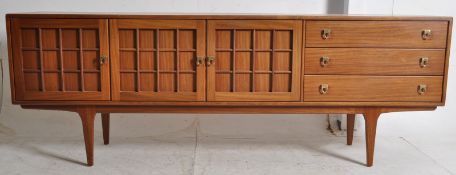A vintage 1970's retro teak sideboard / dresser. Raised on tapered legs supporting a wide body