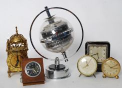 A small collection of travel / desk clocks together with a chrome desk barometer / thermometer