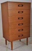 A retro 1970's teak chest of drawers. Raised on tapered legs having an upright body with shaped