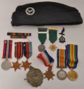 A collection of medals and military badges etc to include World War One Victory medal etc. Inscribed