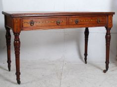 A Victorian oak inlaid writing table desk. Raised on ring turned legs with fitted frieze frame of