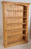 A good quality large country pine library bookcase. Plinth base with upright body having shelves.