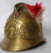 An early 20th century / World War one vintage brass French Firemans Helmet bearing armorial crest to