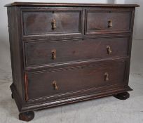 A 1920's Jacobean revival oak chest of drawers. Bun feet with 2 short drawers over 2 deep drawers