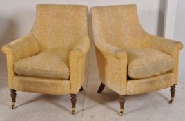 A good pair of Howard style mahogany armchairs. The turned legs with brass cap castors supporting