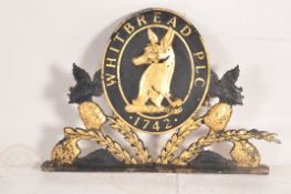 A 20th century Shabby Chic Whitbread PLC armorial pub sign constructed of resin being ebonised