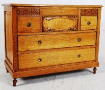 A 1930's Art Deco oak Scottish chest of drawers with a central hat drawer. 81cm x 105cm x 50cm.