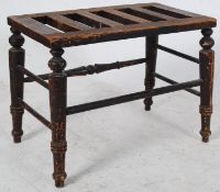 A Victorian 19th century luggage stand / rack / stool being raised on turned legs united by